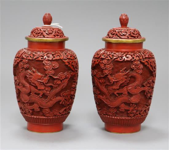 A pair of Chinese cinnabar lacquer dragon jars and lids height 18cm